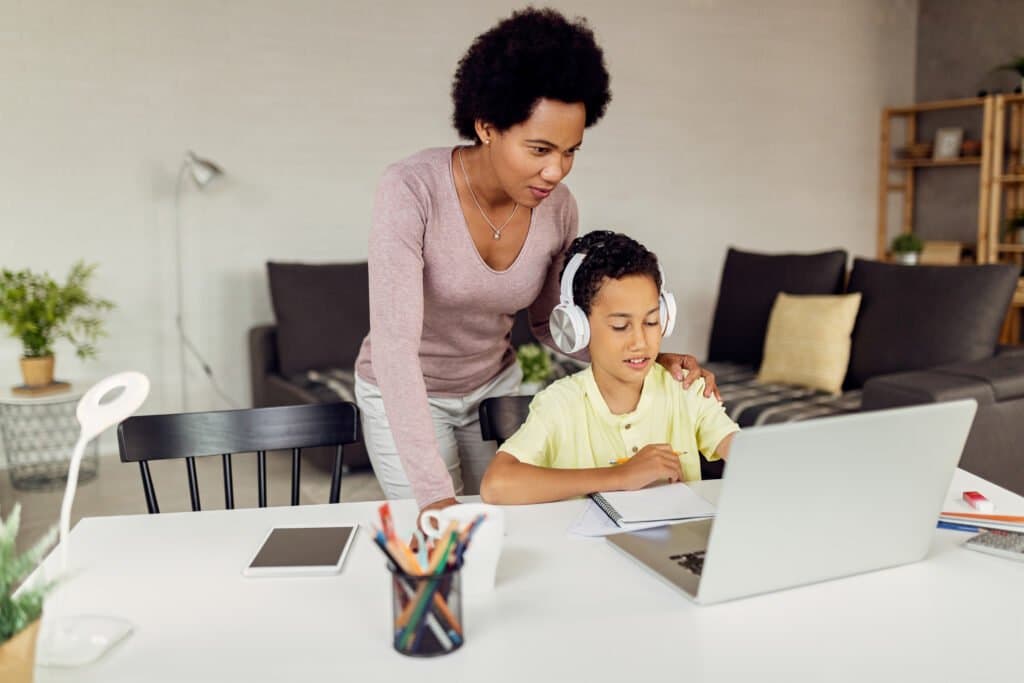 mother-assisting-her-son-homeschooling-curriculum-strategy